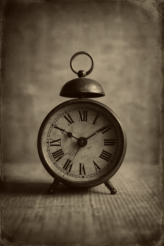 Sepia-toned black-and-white photograph of an antique 1800s metal alarm clock with Roman numerals, sitting on a wooden table. The image has visible film grain, soft lighting, and faded edges, evoking the authentic texture and atmosphere of a 19th-century glass-plate photograph.